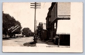 J90/ Juneau Wisconsin RPPC Postcard c1910 Business District Zache Store  193