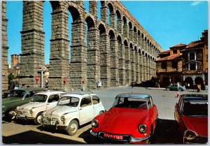 VINTAGE CONTINENTAL SIZE POSTCARD CLASSIC CARS PARKED AT SEGOVIA SPAIN AQUEDUCT