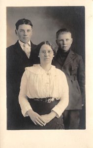 Two young men and a woman Adults & Children Writing on Back 