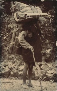 PC INDIA, MAN CARRYING A HUGE PACKAGE, Vintage REAL PHOTO Postcard (b27669)