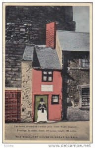 Woman Sitting Down Infront Of The Door, Smallest House, Conway Quay, North Wa...