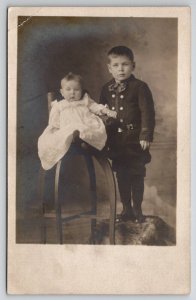 RPPC Sweet Children Brother with Baby Unique Antique Chair c1910 Postcard I28