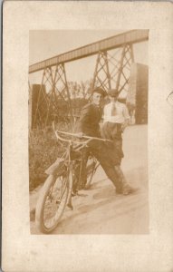 RPPC Young Men with Motorbike Below Railroad Bridge Postcard Y17