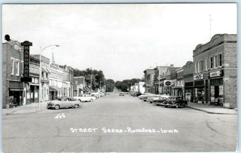 RPPC  ROCKFORD, Iowa  IA    STREET SCENE  Hardware Store 1950s Cars  Postcard