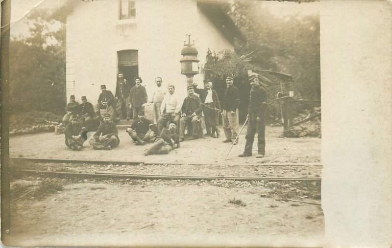 Social history Postcard railway station workers group picture