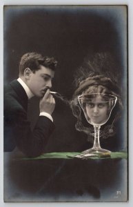 RPPC Fantasy Trick Photography Man Smoke Cigarette Woman Face Glass Postcard R29