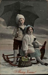 Christmas Children Boy & Girl Sled Money Bags Umbrella c1900s-10s Postcard