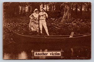 c1910 A Man Helps Woman into Boat on Shore by Woods ANTIQUE Postcard 1688