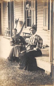 Woman and young girl with dog sitting on front porch Adults & Children Unused 