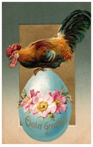 Easter Rooster standing on blue egg