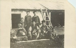 c1918 RPPC Postcard; Siberian Family Seated Outside their Summer House Russia