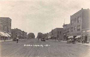 J48/ Storm Lake Iowa RPPC Postcard c1910 Main Street Stores Automobile 209