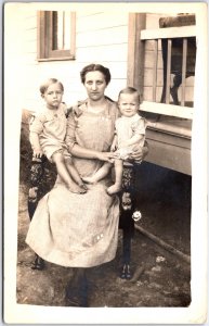 Mother of Two in Long Plaid  Work Dress Sits with Children - Vintage Postcard