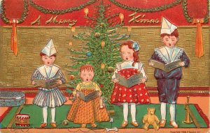 Embossed Christmas Postcard Children in Paper Hats Sing Carols P Sander