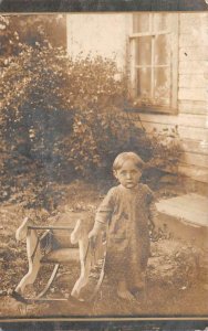 RPPC CHILD AND ROCKING HORSE CHAIR BY HOUSE REAL PHOTO POSTCARD (c. 1910)