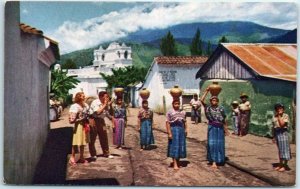 M-22616-1 Guatemalan Women Carrying Water in Earthen Jugs on their Heads