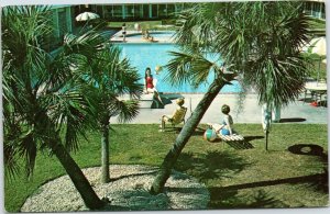 postcard Holiday Inn Tallahassee FL - view of pool through palm trees