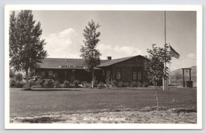 RPPC~The Buffalo Bill Museum~US Flag~Front Entrance~Yard~Cabin Bldg~B&W~Vintage