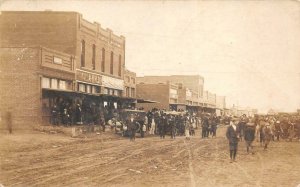 RPPC STREET TOWN SCENE STORE SIGNAGE CARS REAL PHOTO POSTCARD (c. 1910)