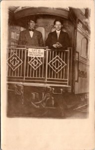 1910 Real Photo Postcard Two Young Men Standing on Train Deck Photo Studio