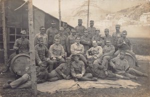 GERMAN WW1 SOLDIERS POSE WITH BEER BARRELS-SOME HOLD BOTTLES~1917 PHOTO POSTCARD