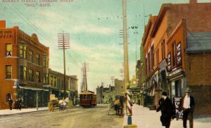 C. 1910 Ashmun St Downtown Trolley Signs Soo, MI Postcard F58 