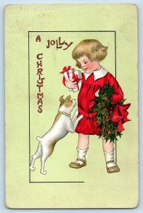 Christmas Postcard Child With Gift And Holly Berries Dog Arlington MN 1913