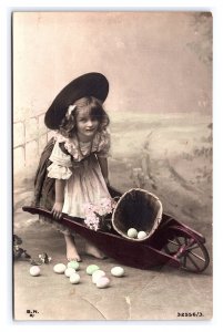 Postcard Young Girl Wheelbarrow Flowers Easter Eggs Hand Colored RPPC B.N.K. #2