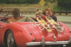 Red Cadillac Sports Car With Extreme Sporting Teenagers Postcard