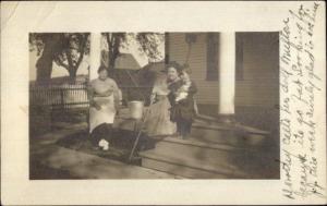 Women & Child w/ Dolly on Porch - Eureka IL Cancel 1914 Real Photo Postcard