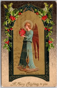 A Merry Christmas To You, 1910 Angel In Arch with Holly Border Embossed Postcard