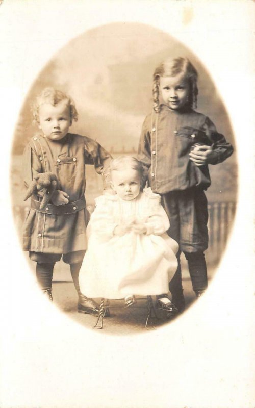 RPPC THREE SISTERS CHILDREN TEDDY BEAR STUDIO REAL PHOTO POSTCARD (c. 1910)