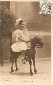 Little girl riding her toy horse. Haute Ecole Old vintage French postcard