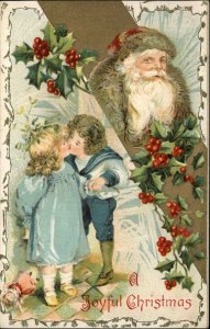 CHRISTMAS Santa Claus in Brown Coat Cute Kids Kissing c1910 Postcard