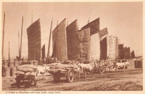 RPPC A WHARF IN MANCHUKUO WITH MANY JUNKS CHINA SHIPS REAL PHOTO POSTCARD 1930s