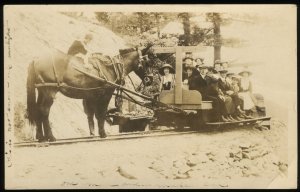 Mule car on rails with passengers. AZO real photo postcard 1922-26