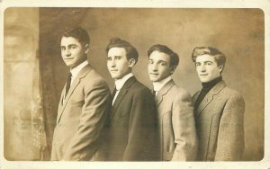 C-1910 Four well dressed young men group photo interior RPPC Postcard 21-373