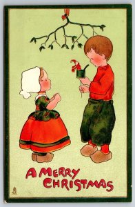 Christmas~Dutch Boy Shows Girl Jack-In-Box Under Mistletoe~Gold~Emb~TUCK~c1910