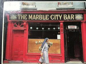 Postcard Nun walking by The Marble City Bar in Kilkenny, Ireland.   4 x 6   T5