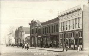 Grundy Center IA Main St. Stores Cars Visible Signs c1910 Real Photo Postcard