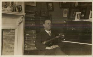 Man Sits w/ Violin & Piano - Bound Books on Shelves c1910 Real Photo Postcard