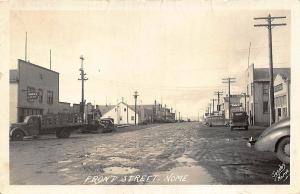 Nome AK Dirt Front Street Store Fronts Trucks Signed Jacobs RPPC Postcard