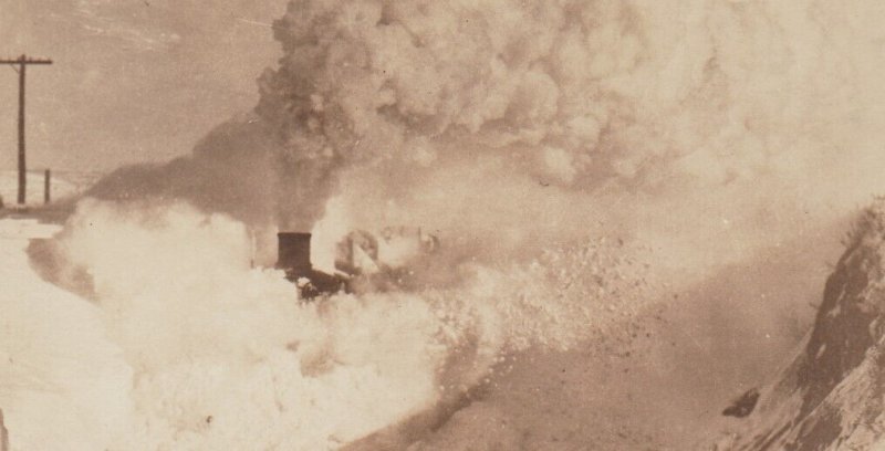 McLaughlin SOUTH DAKOTA RPPC c1910 TRAIN RAMMING SNOW DRIFT Blizzard CM&StP RR 1