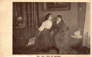 Vintage Postcard 1908 Do It Now! Woman on Chair with Man Asking for a Kiss Love