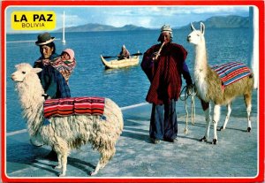 VINTAGE CONTINENTAL SIZE POSTCARD LAKE WITH REED BOAT NATIVE COUPLE BABY BOLIVIA