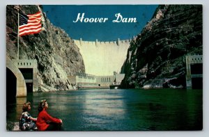 Hoover Dam Nevada & Arizona Ladies with US Flag Background Vintage Postcard 1662