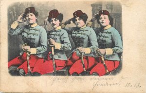 B582 Four women dressed in blue-gray jackets military hussar uniforms, saluting