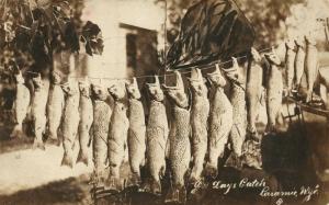 LARAMIE WYO FISHING CATCH ANTIQUE 1922 REAL PHOTO POSTCARD RPPC w/ CORK CANCEL