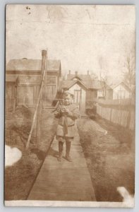 RPPC Adorable Little Boy on Plank Sidewalk Old Shed Barns c1908 Postcard G24