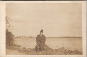 RPPC Dapper Gentleman Derby Hat Riverbank Long Pier in Distance Postcard X8